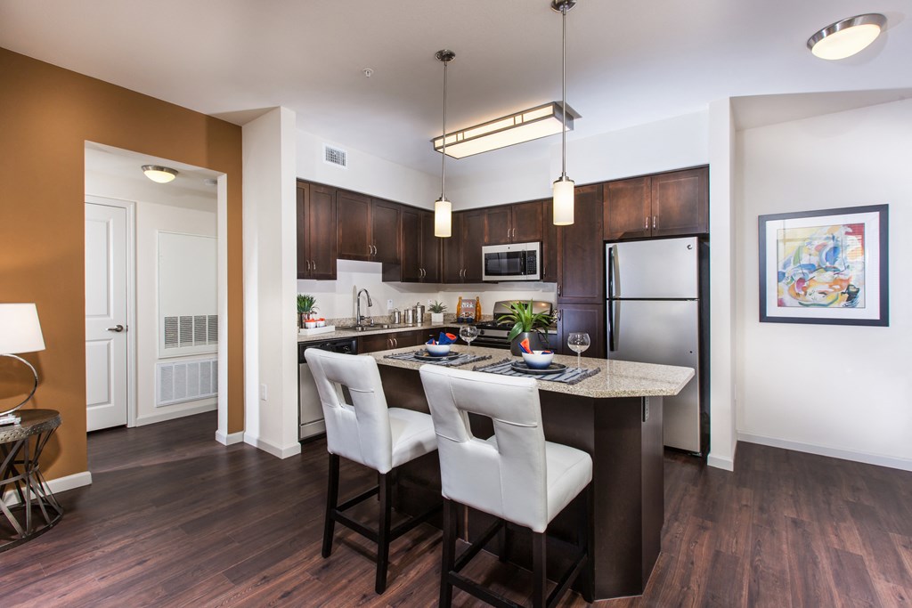 2 BR Apartments in Chino Hills, CA - Capriana at Chino Hills - Modern Kitchen with Stainless-Steel Appliances, Wood-Look Plank Floors, Granite Countertops, and High Nine-Foot Ceilings