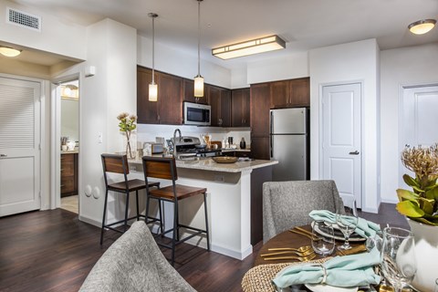 a kitchen and dining room with a table and chairs