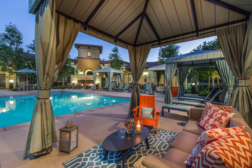 resident pool at night with cabana seating