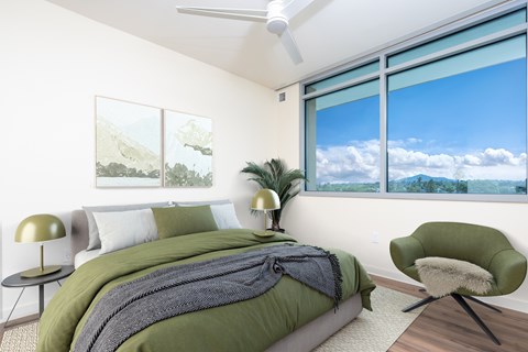 Modern bedroom with green bedding and mountain views at Casa Estilo Apartments, California, 91910