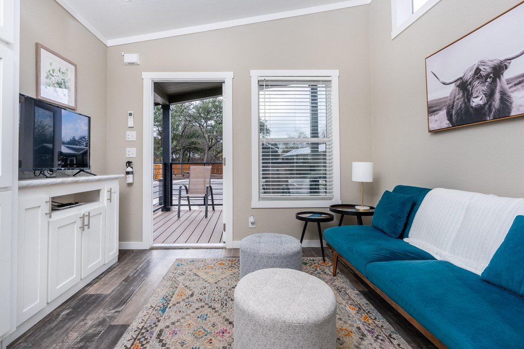 a living room with a blue couch and a tv