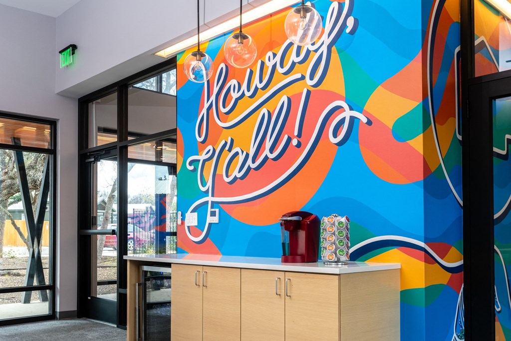 a colorful mural in a restaurant with a counter and glass doors