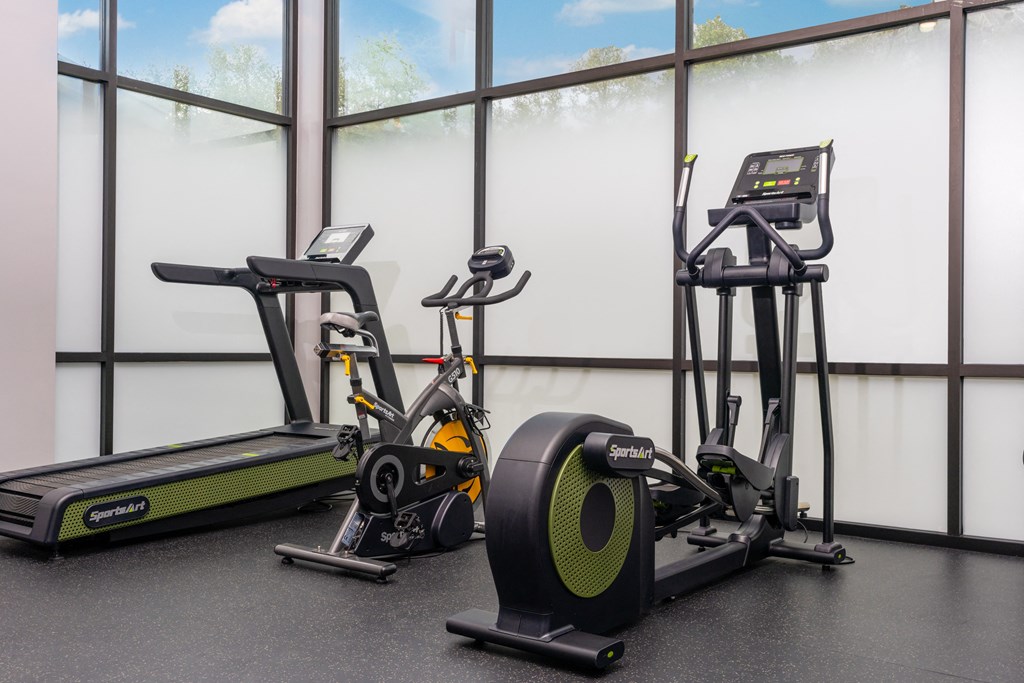 a group of exercise bikes in a gym