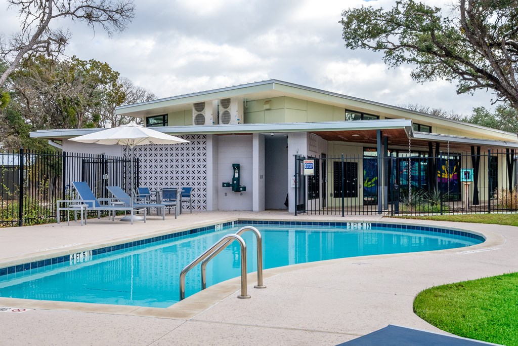 a swimming pool with a building in the background