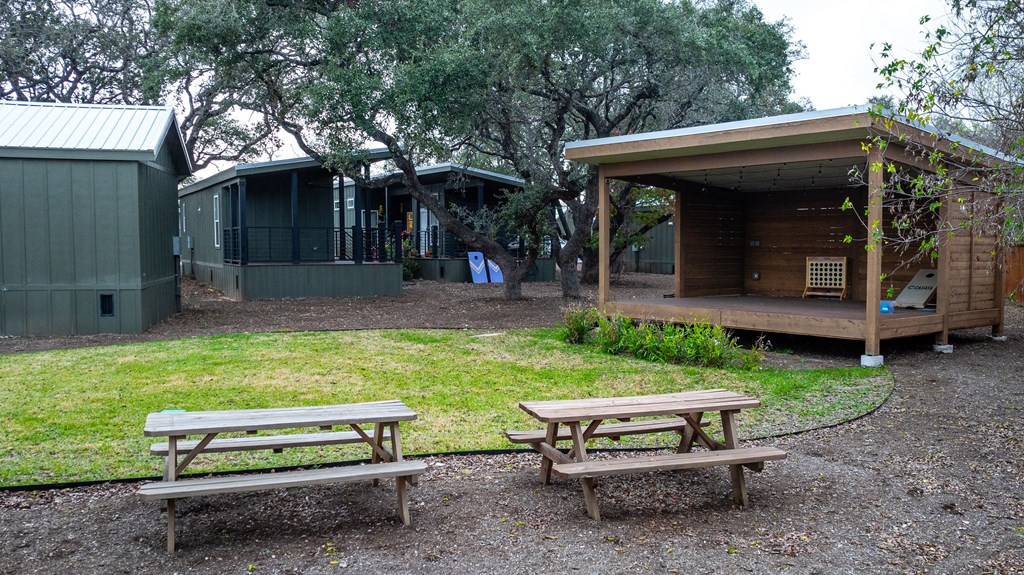 a group of picnic tables in front of a building