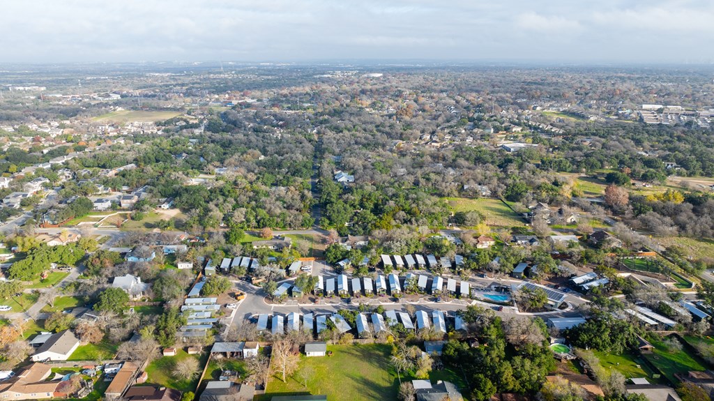an aerial view of a city with houses and trees