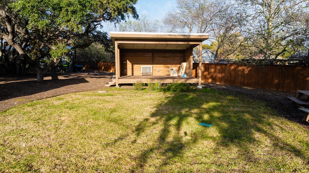 a tiny house in a backyard with a lawn
