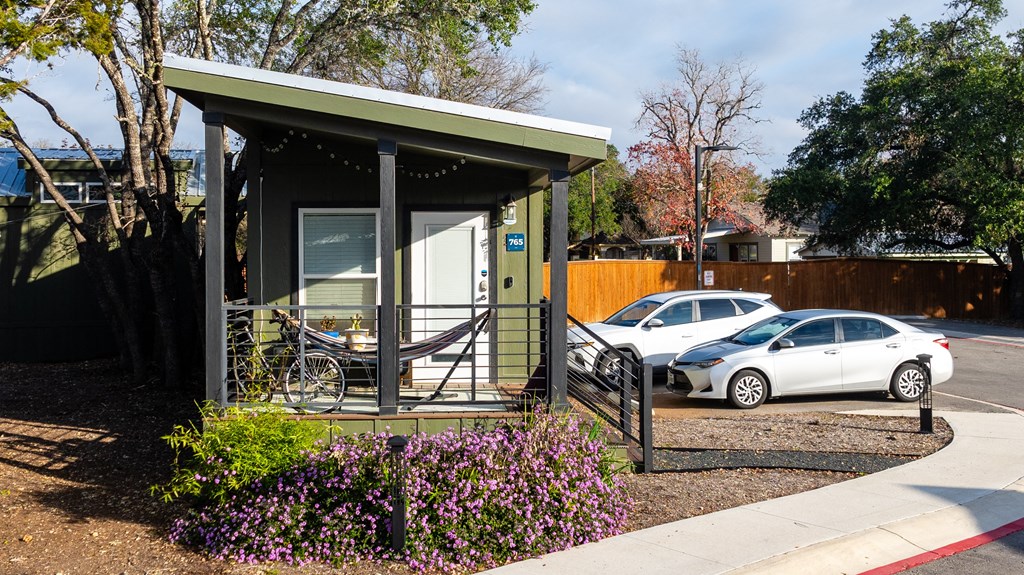 a bus stop with two cars parked in front of it