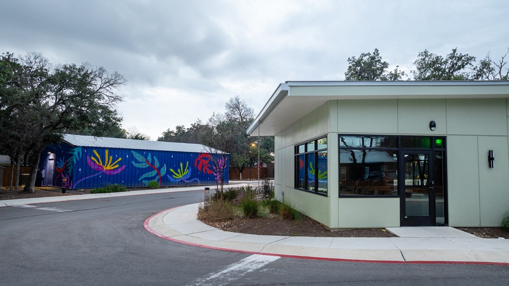 a white building with a mural on the side of it
