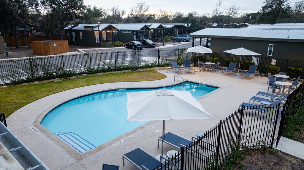 South Austin, TX, Apartments - Casata Austin - Resort-Style Swimming Pool With Lounge Seats, Tables, Chairs, And Umbrellas
