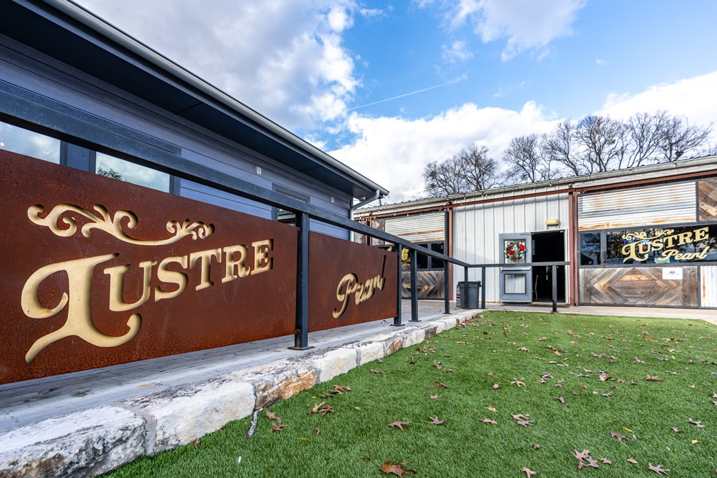 the outside of a restaurant with a lawn and a sign that reads justice