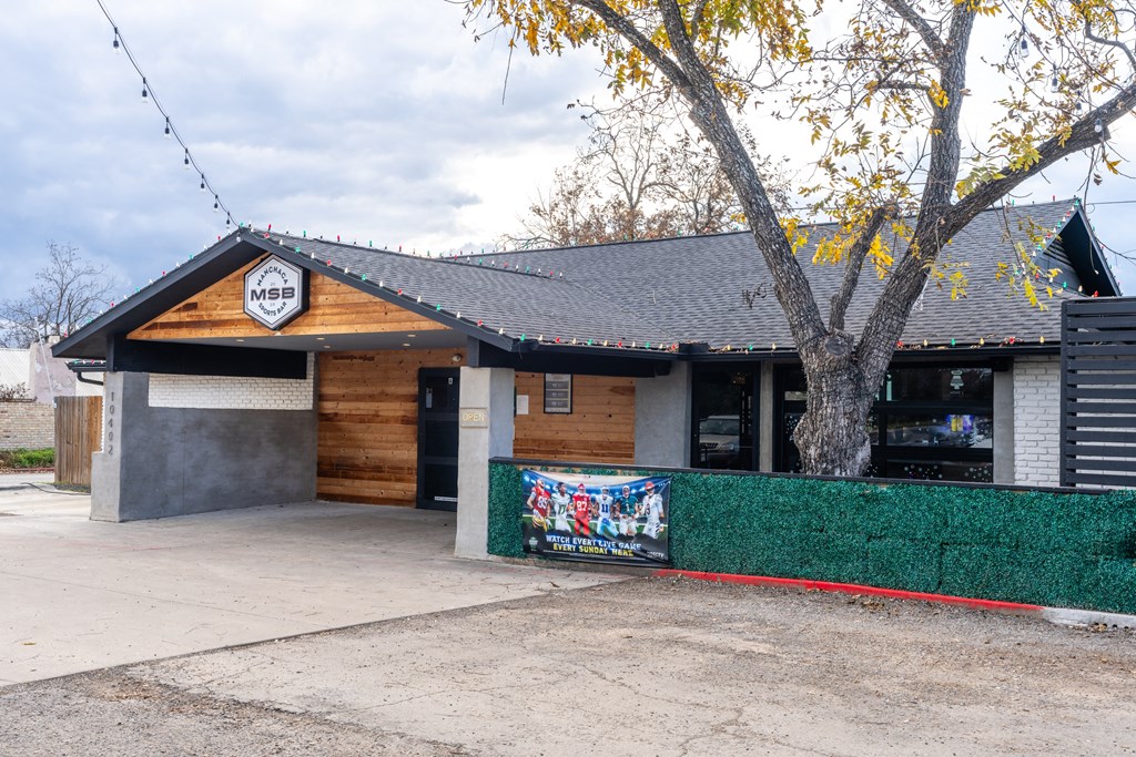 the front of a building with a sign on the side of it