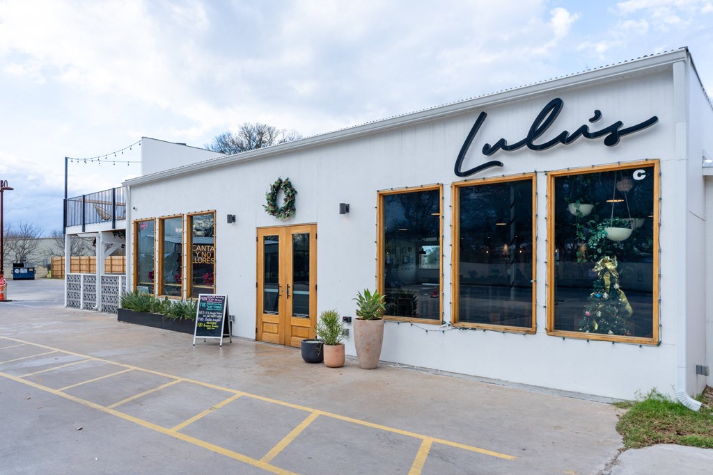 the exterior of a white building with windows and a sign that reads lulus