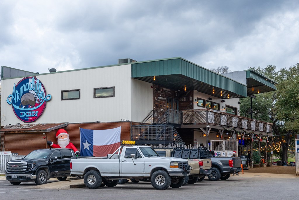 a building with trucks parked in front of it and a santa claus sign