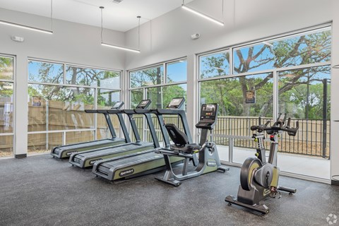 A gym with treadmills and exercise bikes.