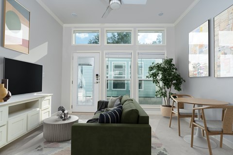 A living room with a green couch and a television.