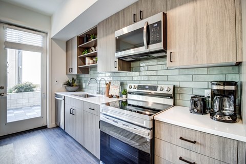 A kitchen with a stove top oven and a microwave.