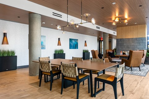 A modern dining room with a long table and chairs.