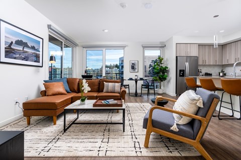 A living room with a brown sofa and a black coffee table.