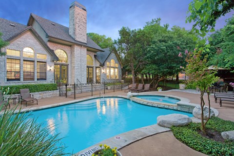 North Austin, TX, Apartments with In-Unit Washer and Dryer - Museo Channings Mark - Swimming Pool With Sundeck, Lounge Chairs, Poolside Picnic Area, And Lush Trees.