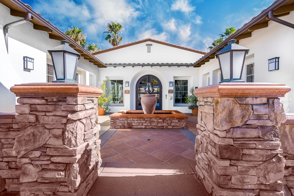 abuilding with a fountain in the middle of a courtyard