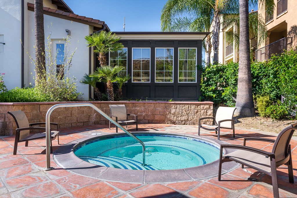 Hot tub with seating and building in the background