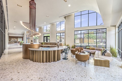 A modern interior with a curved reception desk and a large window.