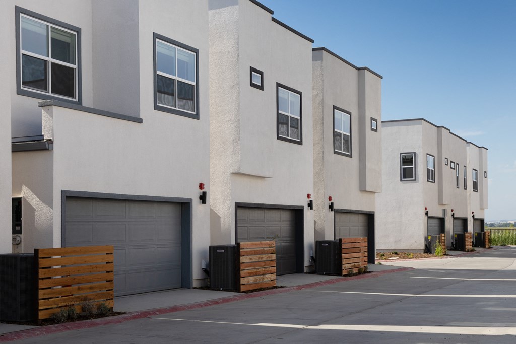 a row of apartment buildings with garages