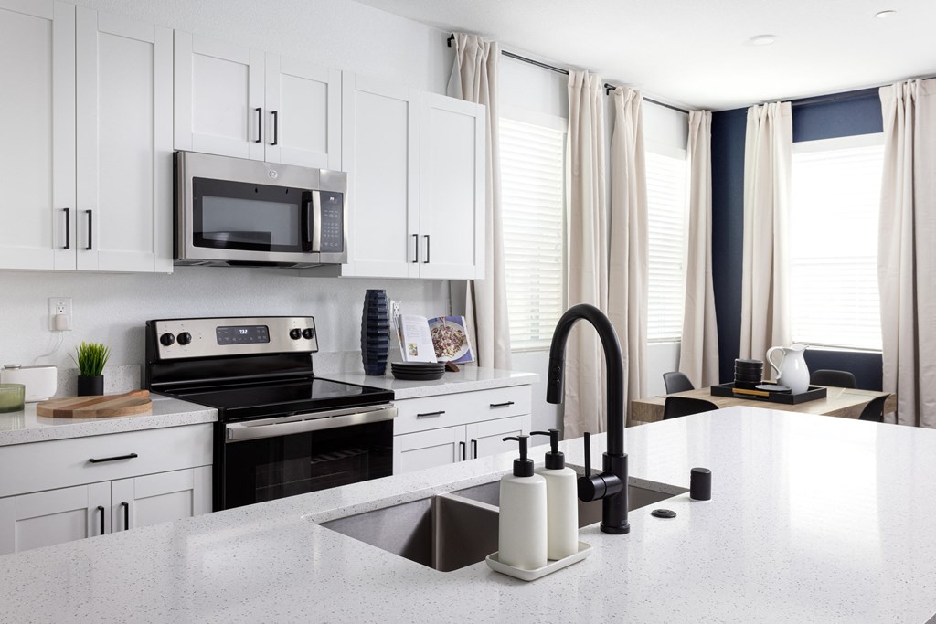 a kitchen with white cabinets and a white counter top