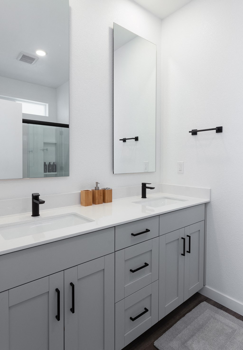 a white bathroom with two sinks and a large mirror