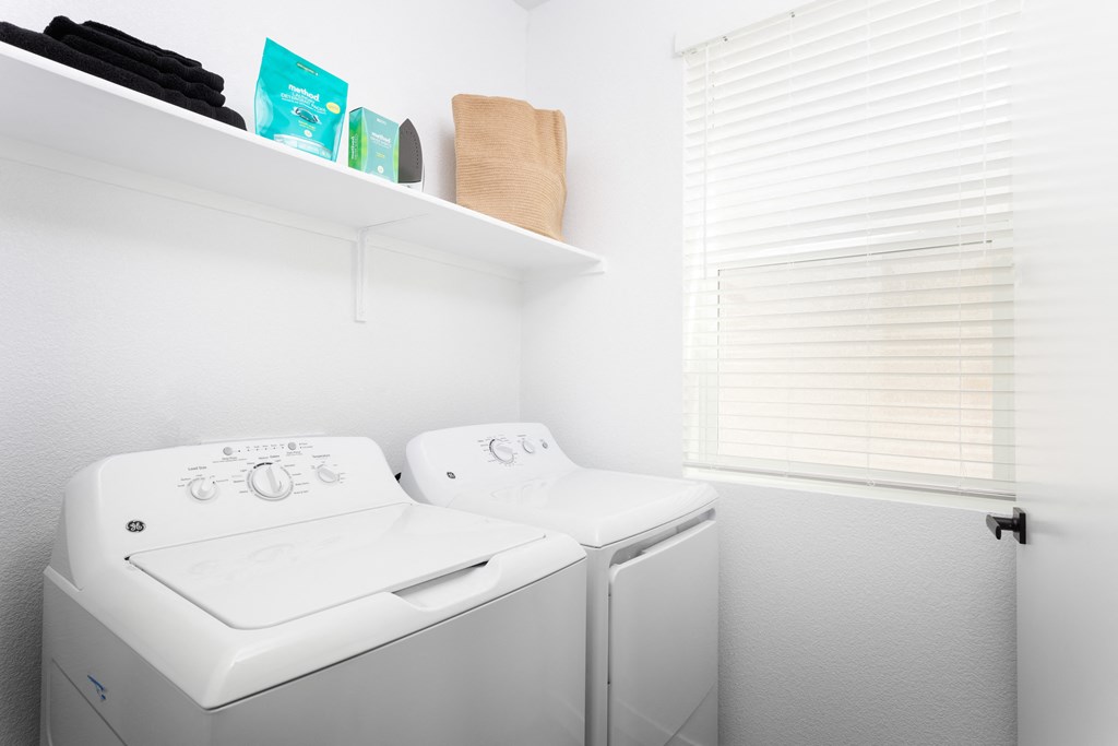 a small laundry room with a washer and dryer