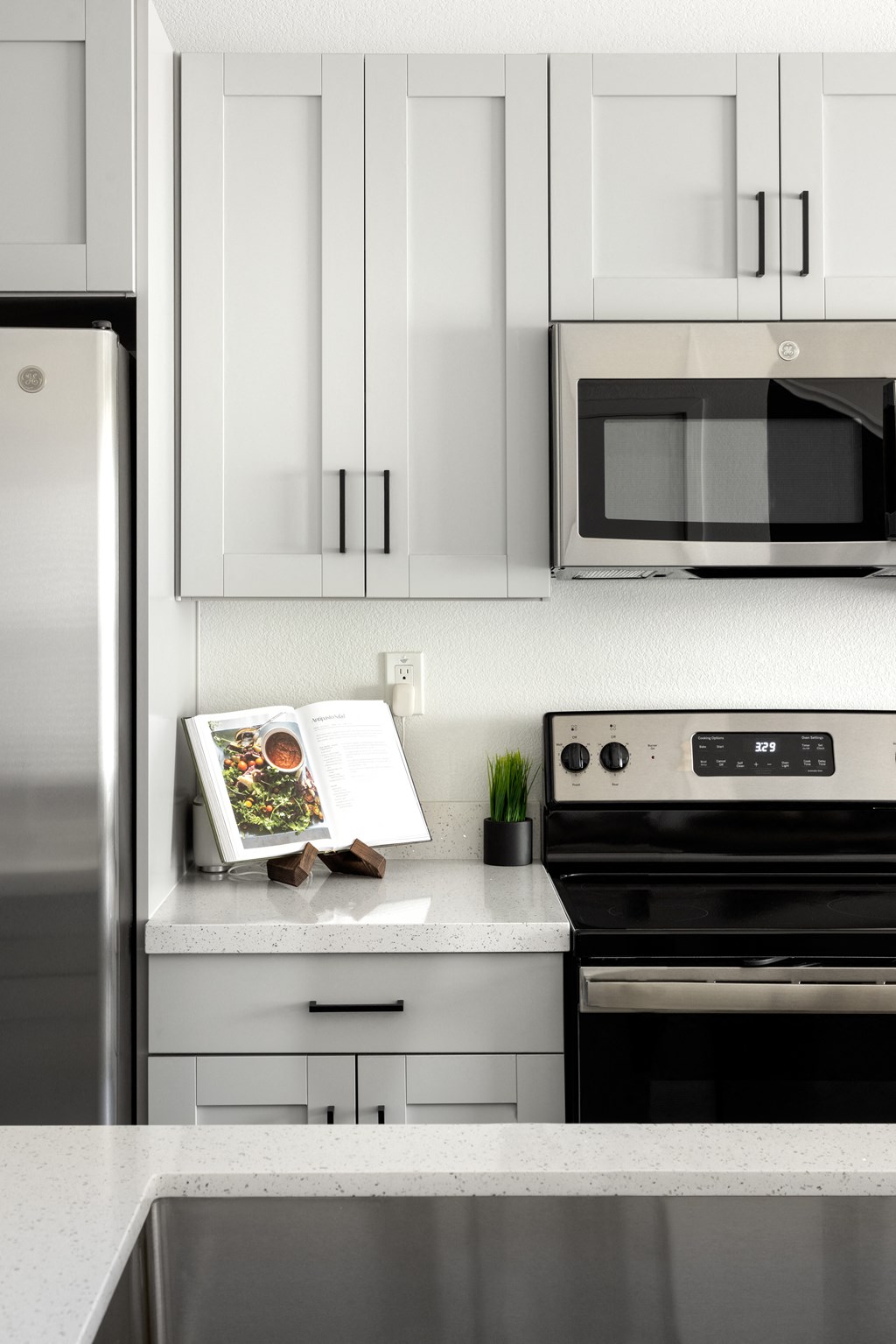 a kitchen with white cabinets and stainless steel appliances