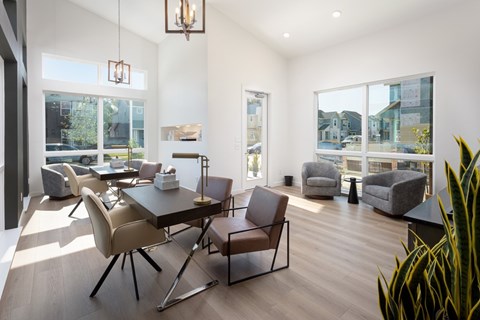A modern dining room with a glass table and chairs.