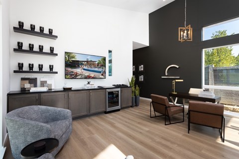 A modern living room with a grey sofa and a wooden floor.