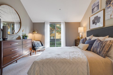 Bedroom with sliding glass doors to patio at Americana Apartments, Mountain View, CA