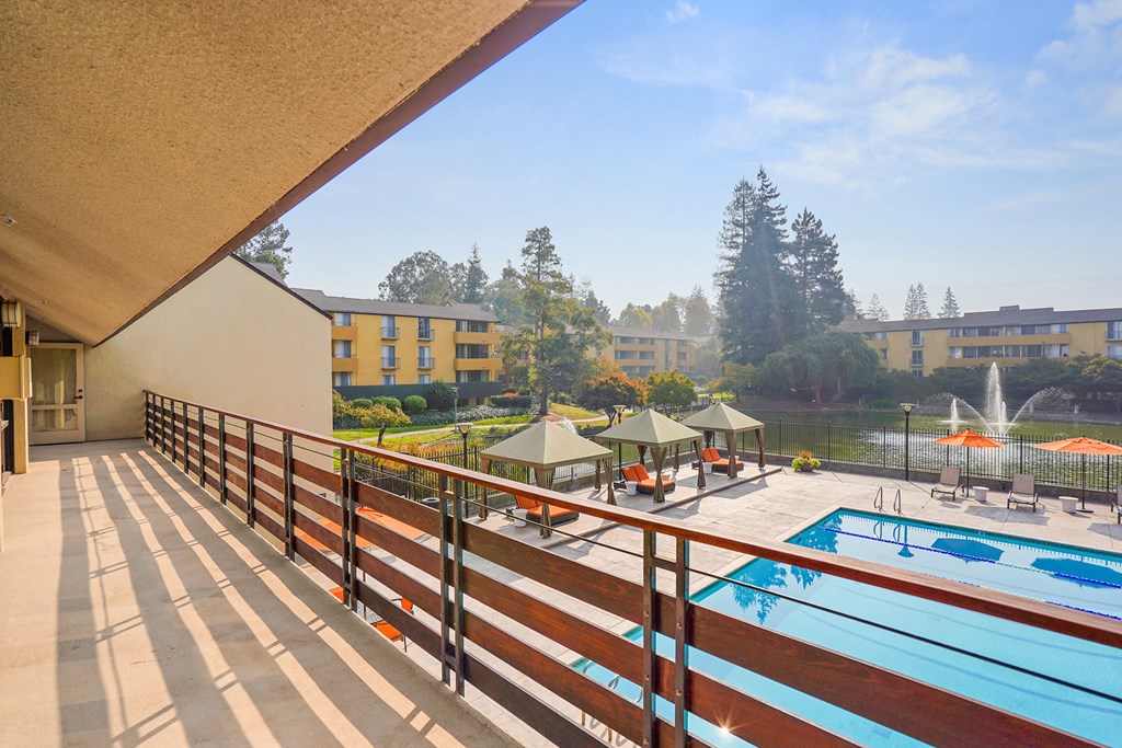 Balcony view of pool and pond at Americana Apartments, California, 94040
