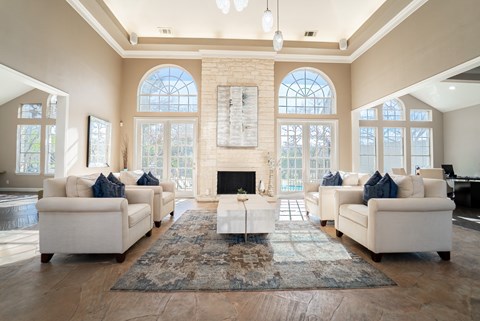 A living room with a fireplace and a rug in front of it.