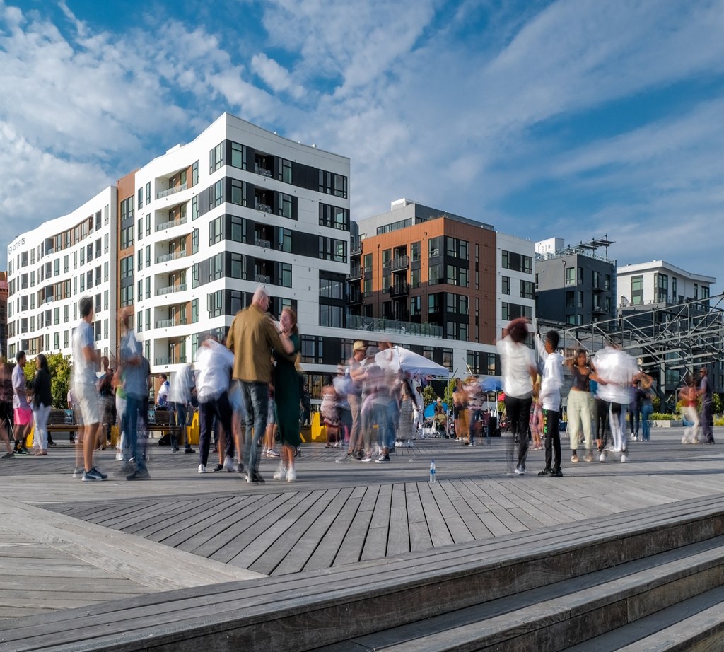 people walking on the boardwalk in the city