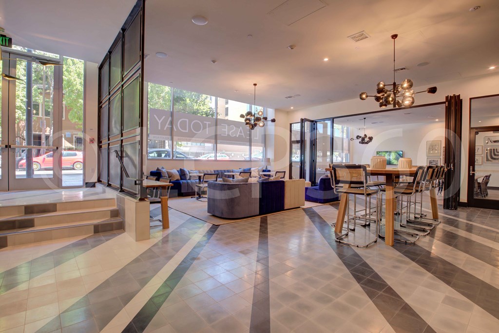 a living room with a table and chairs and glass doors