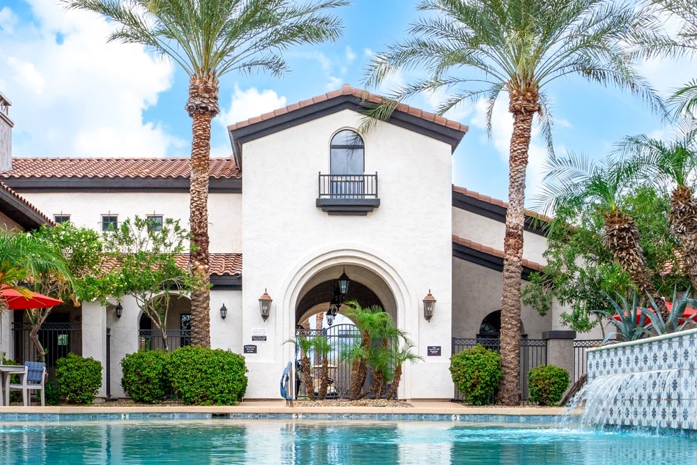 swimming pool with covered seating and lots of plants
