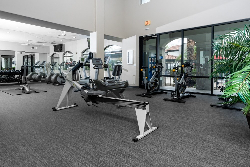 a gym with cardio machines and weights at the renaissance valencia resort and spa