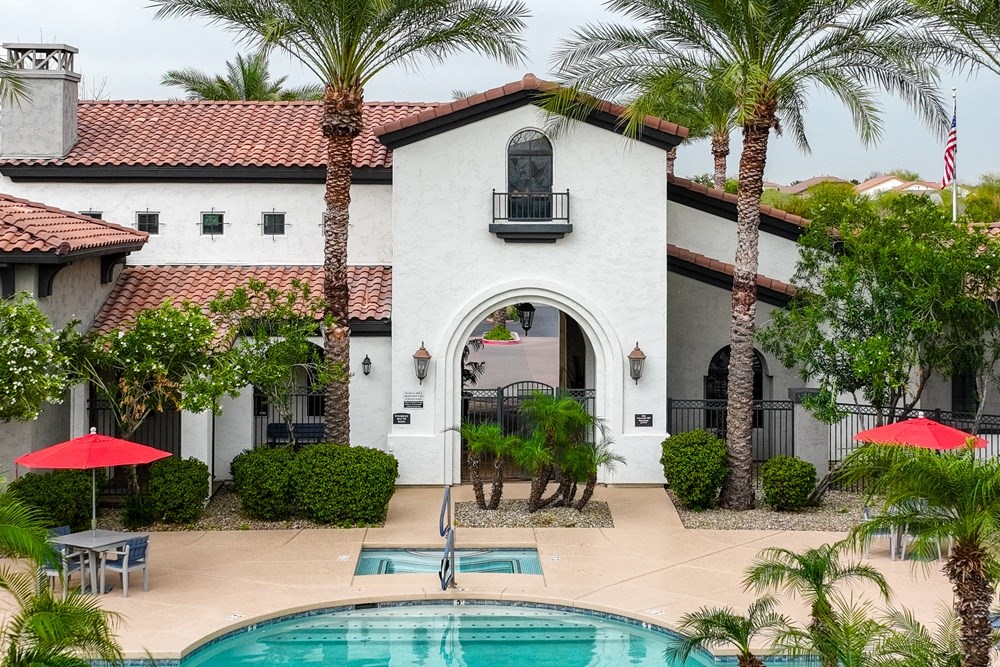 a house with a swimming pool and palm trees