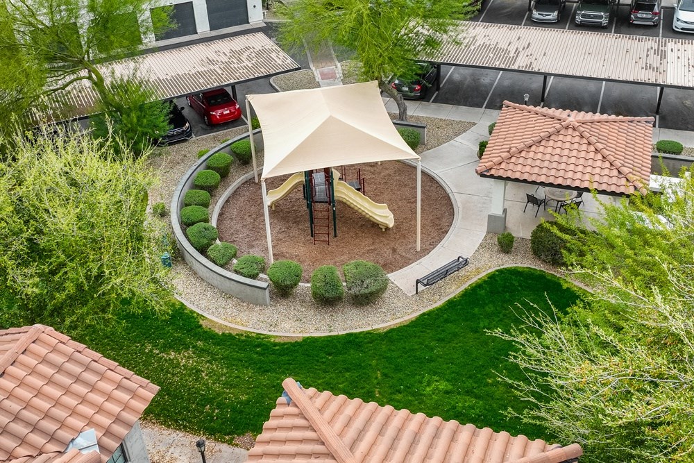 an aerial view of a playground in the yard of a house