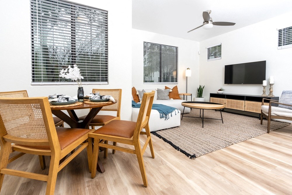 a living room and dining room with a couch and a tv