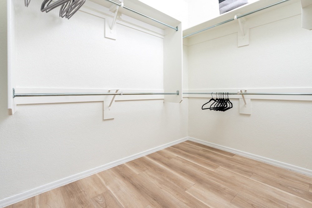 an empty room with white walls and a wood floor