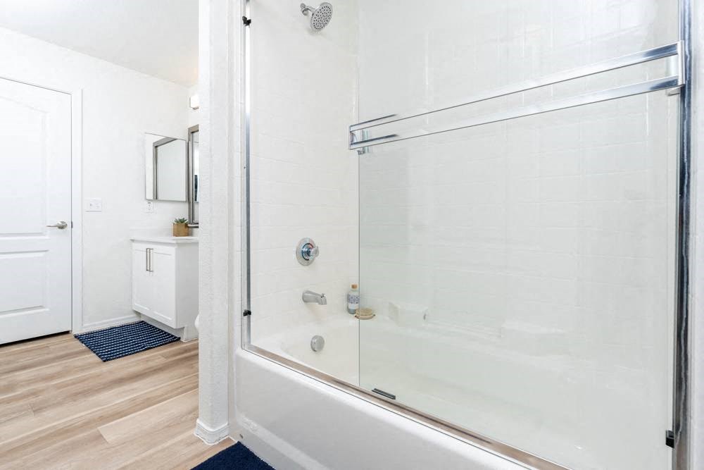 a bathroom with a shower and a sink