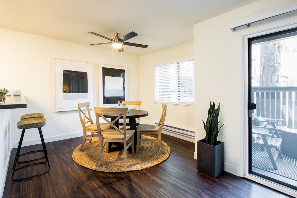 A dining room with a round table and chairs.
