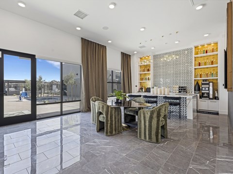 A modern dining room with a table set for two and a view of the outdoors.