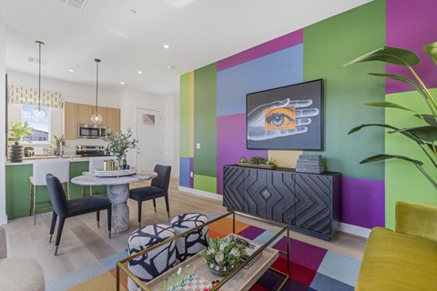 A modern living room with a dining table and chairs.