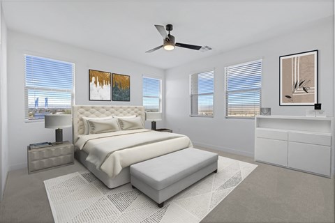 A bedroom with a large bed and a ceiling fan.